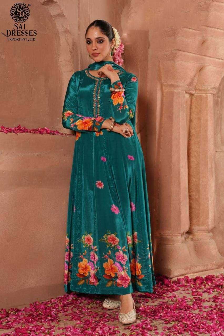 STUNNING TEAL BLUE VELVET ANARKALI SUIT WITH BRIGHT FLORAL PRINTS AND EMBROIDERED DETAILING – ELEGANCE IN EVERY FOLD.